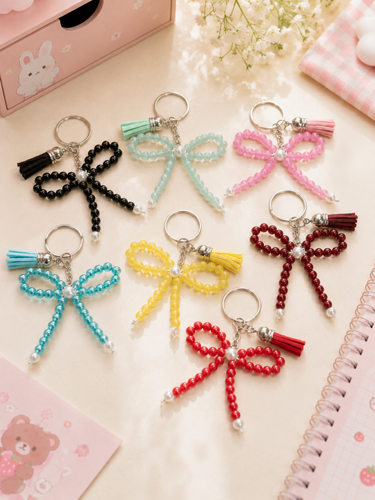 7 porte-clés nœud en perles colorées avec pompon assorti : noir, bleu menthe, rose, turquoise, jaune, bordeaux et rouge