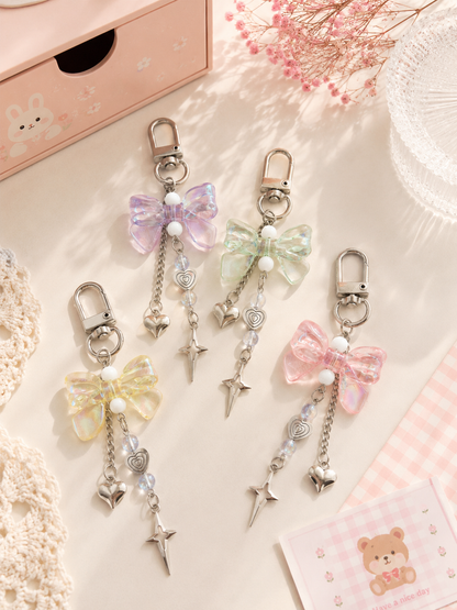 4 porte-clés nœud cristal iridescent avec chaîne cœur et étoile argentée en 4 coloris : violet, vert menthe, jaune pastel et rose